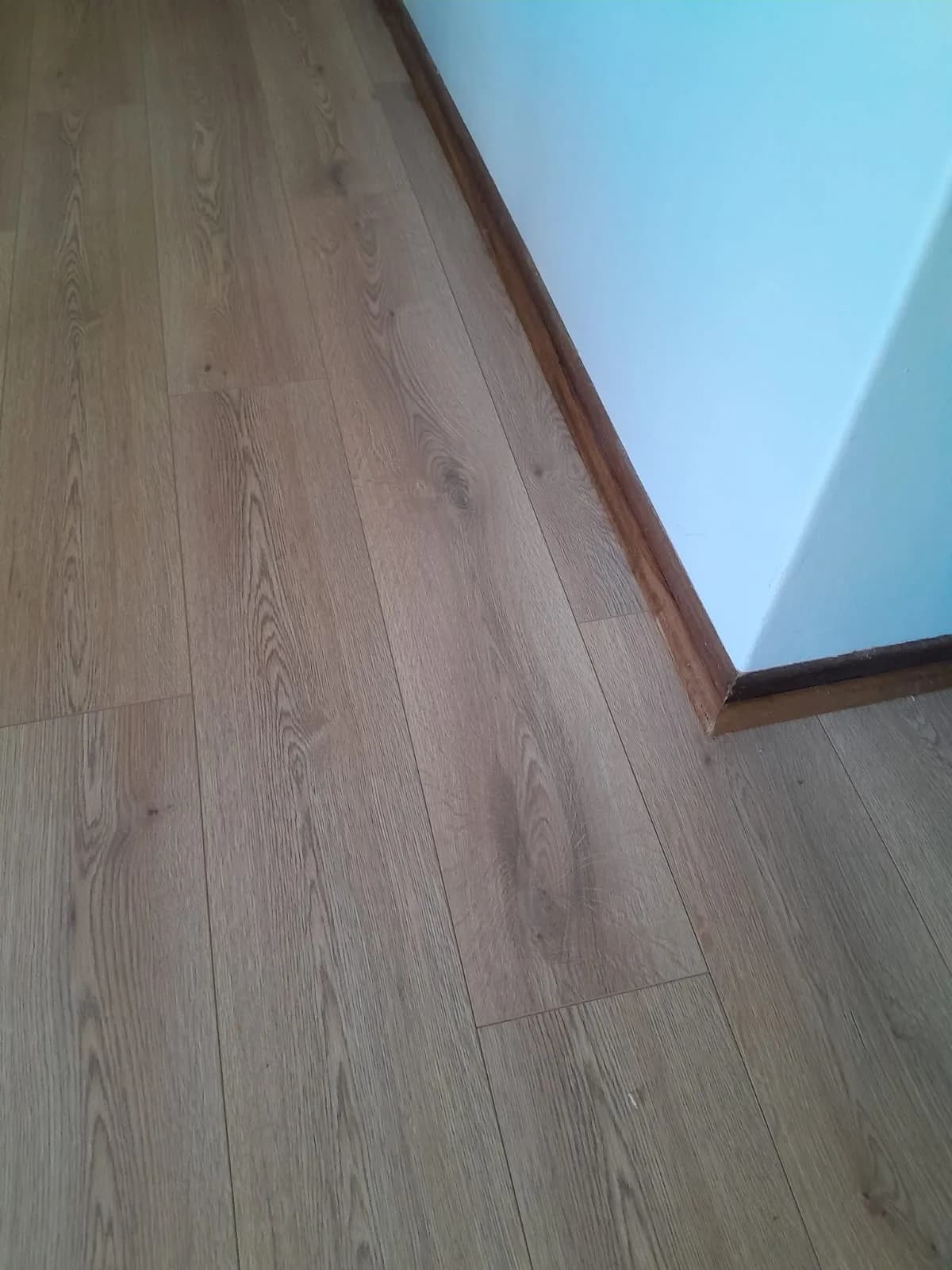 Close-up of a finished laminate flooring installation